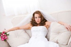 woman with wedding gown sitting on sofa
