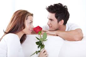 A couple staring each other on sofa