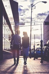 A couple holding hands and walking
